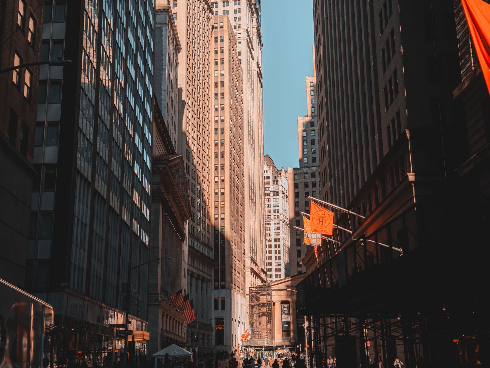 Sunlit street between Financial District skyscrapers